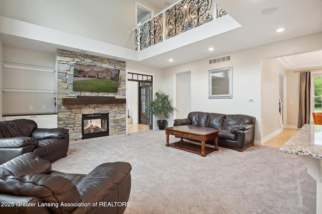 4700 Canyon Trl, Lansing, MI 48917 - carpeted living area featuring recessed lighting, a stone fireplace, and a towering ceiling