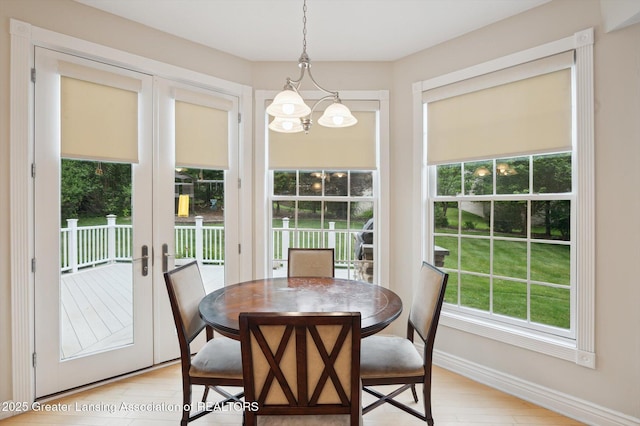 4700 Canyon Trl, Lansing, MI 48917 - dining room featuring french doors, a chandelier, and light wood-style floors