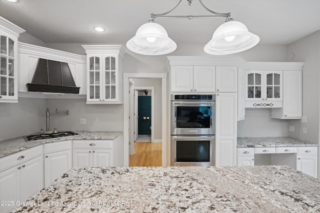 4700 Canyon Trl, Lansing, MI 48917 - kitchen with double oven, white cabinets, glass insert cabinets, light stone counters, and recessed lighting