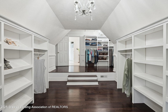 4700 Canyon Trl, Lansing, MI 48917 - spacious closet featuring lofted ceiling, wood finished floors, and a chandelier