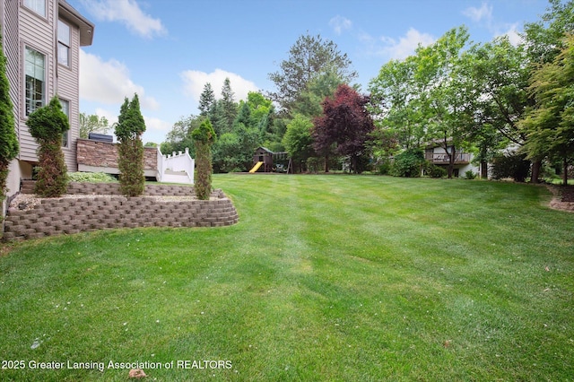 4700 Canyon Trl, Lansing, MI 48917 - view of green lawn featuring a playground