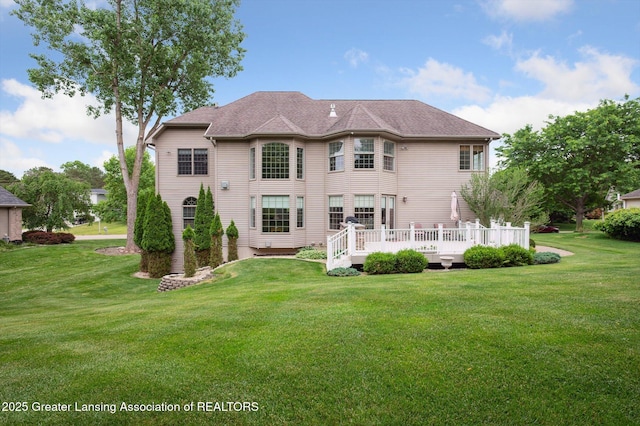4700 Canyon Trl, Lansing, MI 48917 - back of house with a lawn and a deck