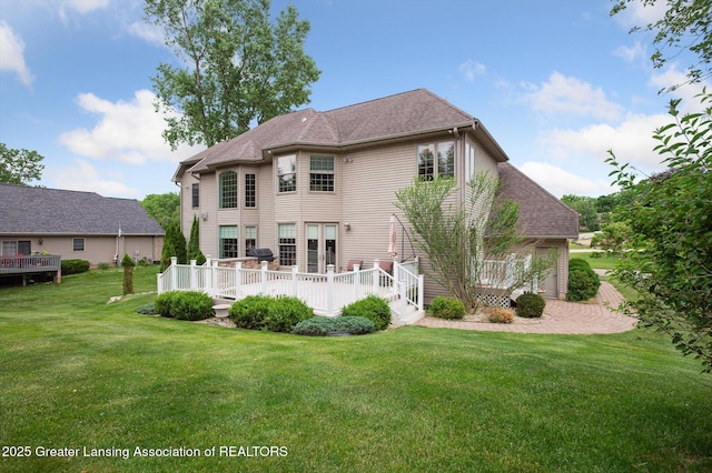 4700 Canyon Trl, Lansing, MI 48917 - rear view of property featuring a deck and a lawn