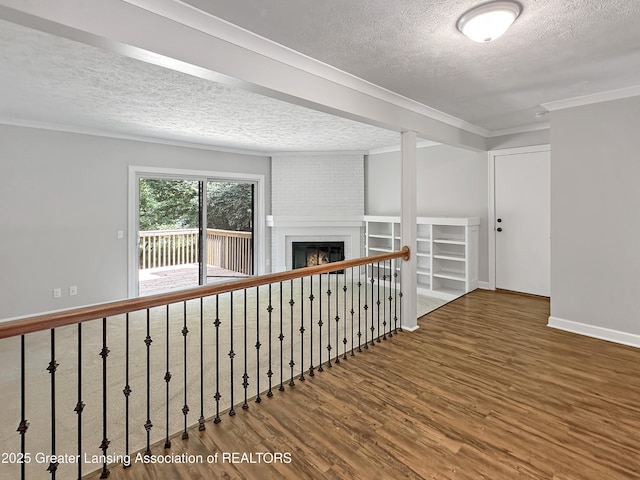 1869 E Burrwood Cir, East Lansing, MI 48823 - hallway featuring a textured ceiling, wood finished floors, and ornamental molding