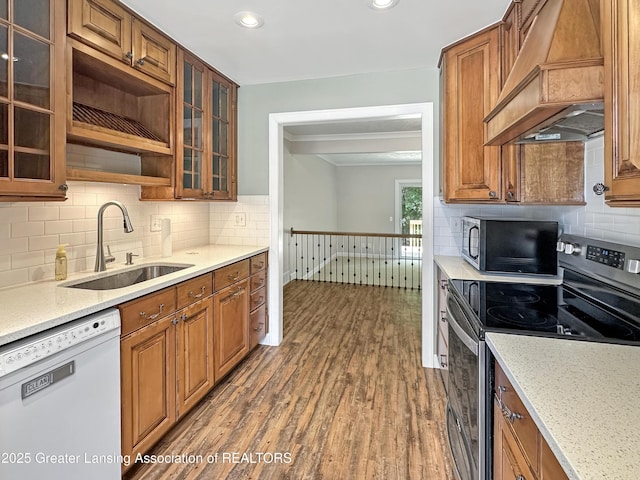 1869 E Burrwood Cir, East Lansing, MI 48823 - kitchen featuring dishwasher, stainless steel range with electric cooktop, custom range hood, wood finished floors, and brown cabinetry