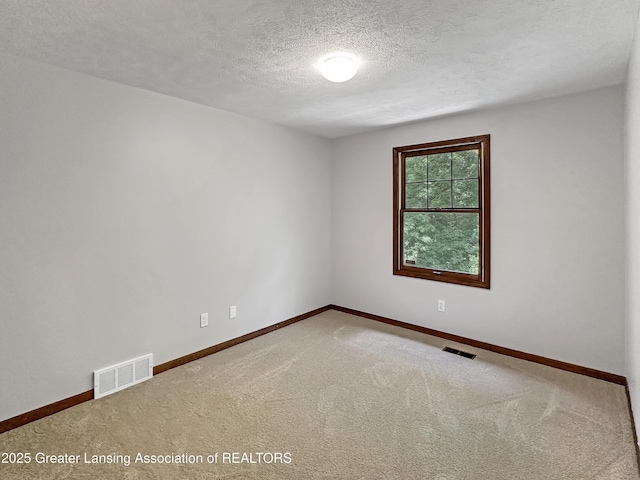 1869 E Burrwood Cir, East Lansing, MI 48823 - unfurnished room with a textured ceiling and carpet
