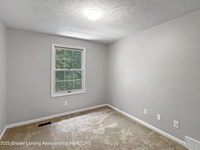1869 E Burrwood Cir, East Lansing, MI 48823 - carpeted empty room with a textured ceiling and baseboards
