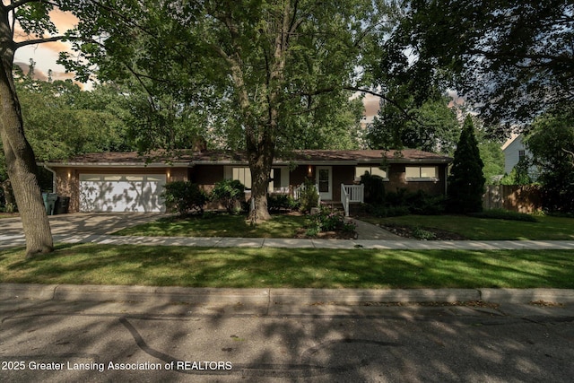 522 Cowley Ave, East Lansing, MI 48823 - ranch-style home featuring an attached garage, concrete driveway, and a lawn
