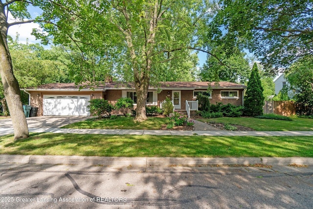 522 Cowley Ave, East Lansing, MI 48823 - ranch-style home with an attached garage, brick siding, and driveway