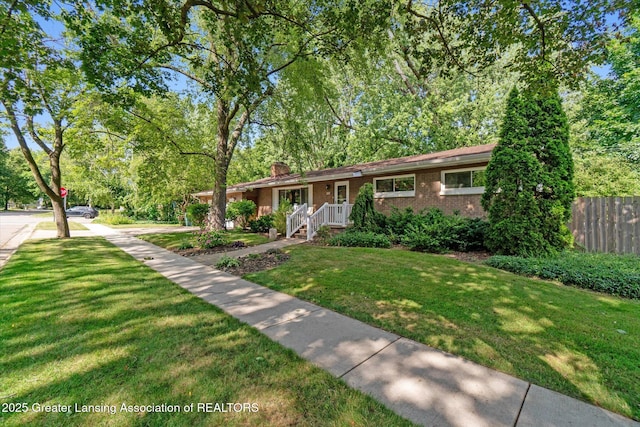 522 Cowley Ave, East Lansing, MI 48823 - view of front facade featuring brick siding and a chimney