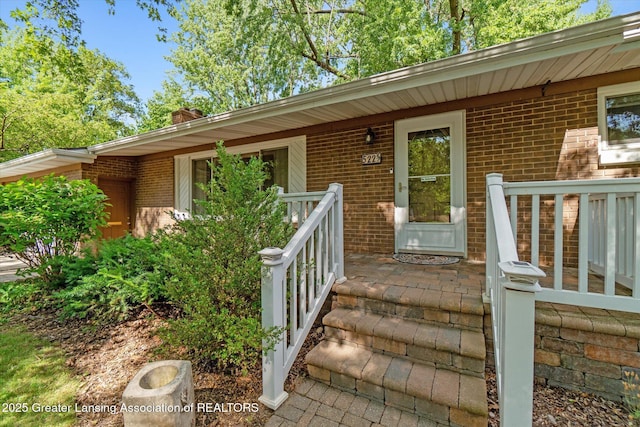 522 Cowley Ave, East Lansing, MI 48823 - entrance to property with brick siding, covered porch, and a chimney