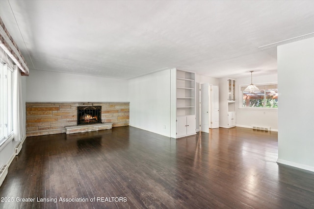 522 Cowley Ave, East Lansing, MI 48823 - unfurnished living room featuring a fireplace, wood finished floors, and built in shelves