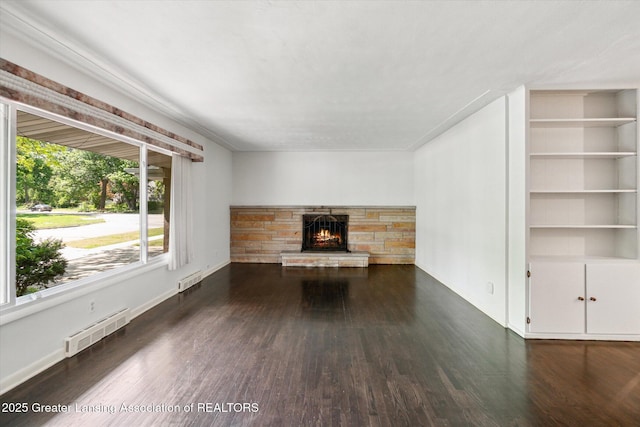 522 Cowley Ave, East Lansing, MI 48823 - unfurnished living room featuring wood finished floors, a fireplace, and built in features