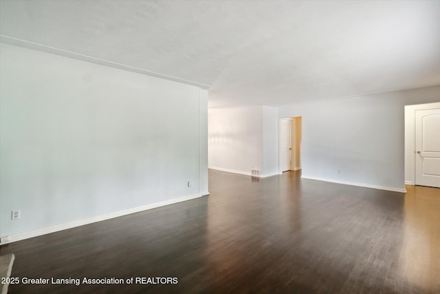 522 Cowley Ave, East Lansing, MI 48823 - empty room featuring dark wood-style floors and baseboards