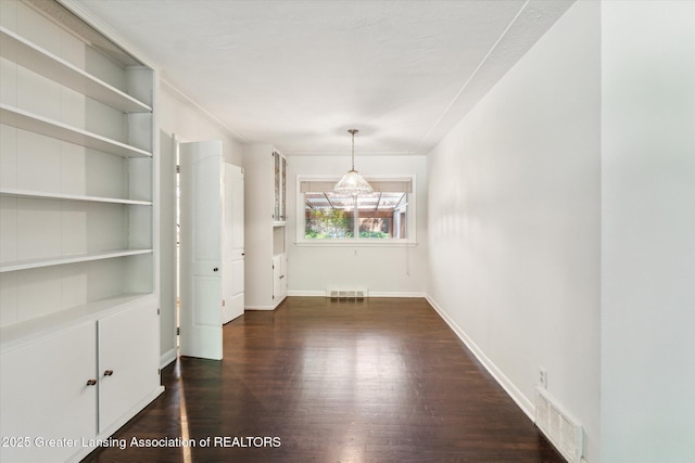 522 Cowley Ave, East Lansing, MI 48823 - unfurnished dining area with dark wood finished floors and built in features