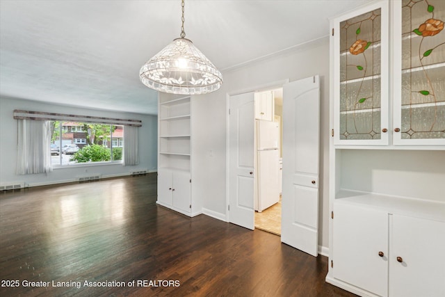 522 Cowley Ave, East Lansing, MI 48823 - unfurnished dining area with a chandelier, dark wood-style floors, and crown molding