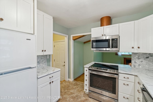 522 Cowley Ave, East Lansing, MI 48823 - kitchen featuring appliances with stainless steel finishes, white cabinetry, and decorative backsplash