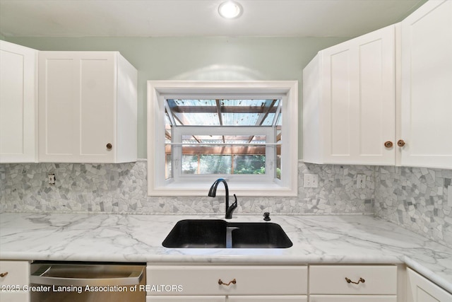 522 Cowley Ave, East Lansing, MI 48823 - kitchen featuring stainless steel dishwasher, backsplash, and white cabinetry