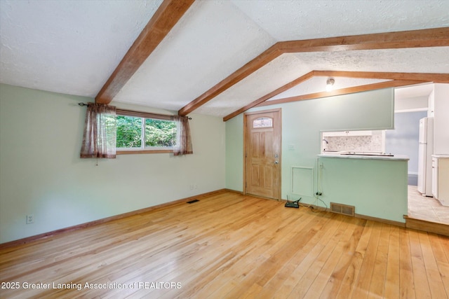 522 Cowley Ave, East Lansing, MI 48823 - unfurnished living room with hardwood / wood-style floors and baseboards