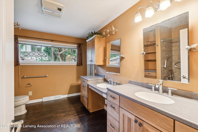 522 Cowley Ave, East Lansing, MI 48823 - bathroom with vanity, tiled shower, and wood finished floors