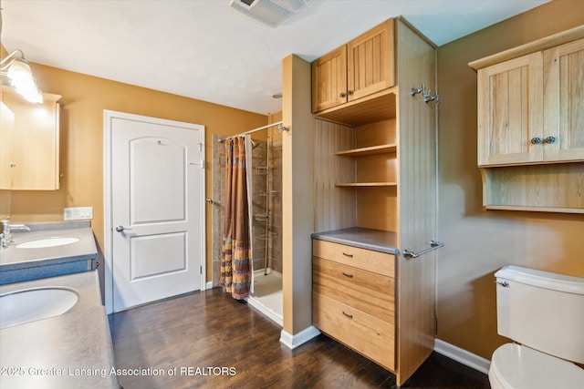522 Cowley Ave, East Lansing, MI 48823 - bathroom with a shower with curtain, wood finished floors, and double vanity