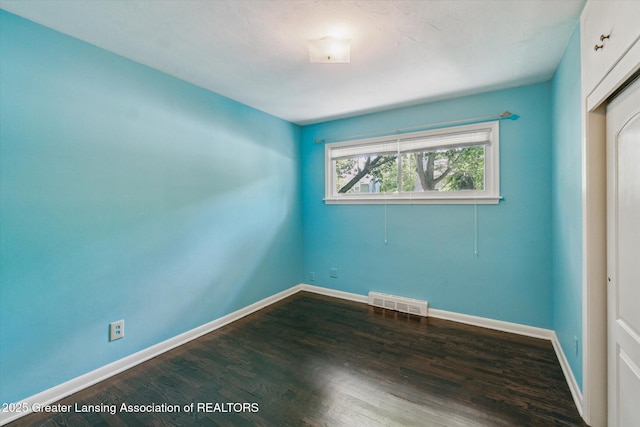 522 Cowley Ave, East Lansing, MI 48823 - empty room featuring dark wood-style flooring and baseboards