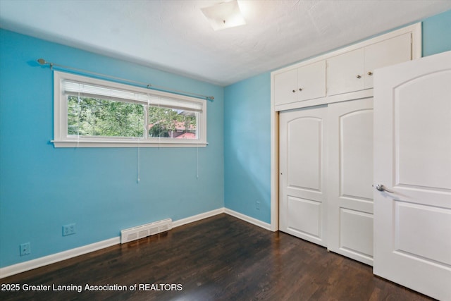 522 Cowley Ave, East Lansing, MI 48823 - unfurnished bedroom featuring dark wood finished floors and a closet