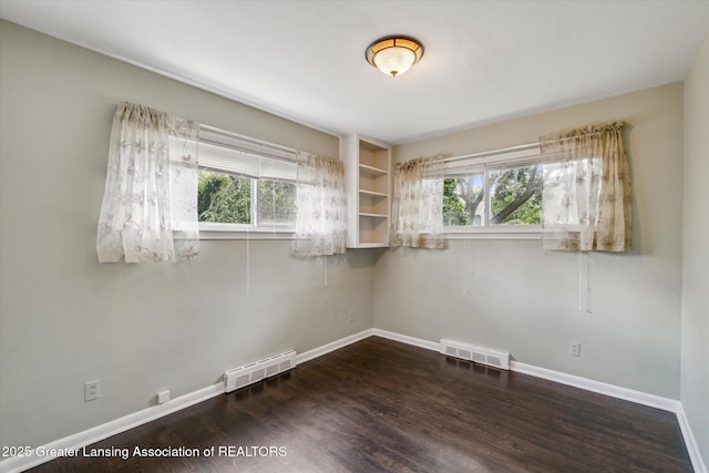 522 Cowley Ave, East Lansing, MI 48823 - empty room with healthy amount of natural light and wood finished floors