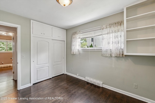 522 Cowley Ave, East Lansing, MI 48823 - unfurnished bedroom featuring a closet and dark wood-style floors