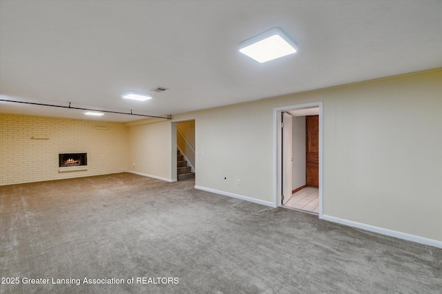 522 Cowley Ave, East Lansing, MI 48823 - finished basement featuring carpet flooring, stairs, brick wall, and a fireplace