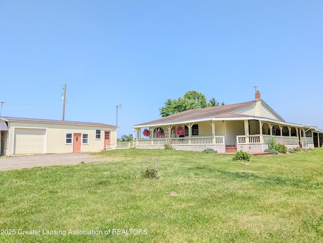 4963 E Portland Rd, Portland, MI 48875 - country-style home featuring covered porch, a front yard, driveway, a chimney, and a garage