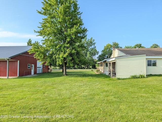 4963 E Portland Rd, Portland, MI 48875 - view of grassy yard with a pole building, a detached garage, and an outbuilding