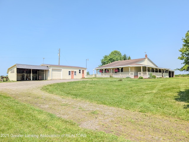 4963 E Portland Rd, Portland, MI 48875 - view of front of home featuring dirt driveway, an outbuilding, a front yard, a carport, and an attached garage