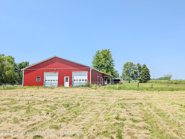 4963 E Portland Rd, Portland, MI 48875 - view of yard with a pole building, an outbuilding, a detached garage, and a rural view