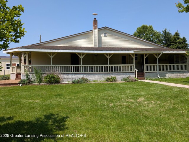 4963 E Portland Rd, Portland, MI 48875 - country-style home featuring covered porch, a front lawn, and a chimney