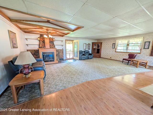 4963 E Portland Rd, Portland, MI 48875 - living area with wallpapered walls, wood finished floors, a glass covered fireplace, and a chandelier