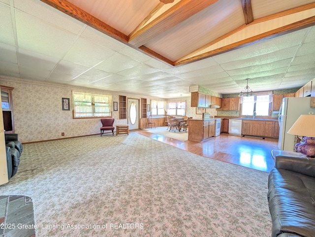 4963 E Portland Rd, Portland, MI 48875 - living room with light carpet, wallpapered walls, and a chandelier