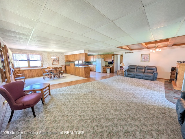 4963 E Portland Rd, Portland, MI 48875 - living area featuring a drop ceiling and baseboards