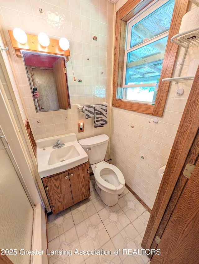 4963 E Portland Rd, Portland, MI 48875 - bathroom with tile walls, vanity, and tile patterned flooring