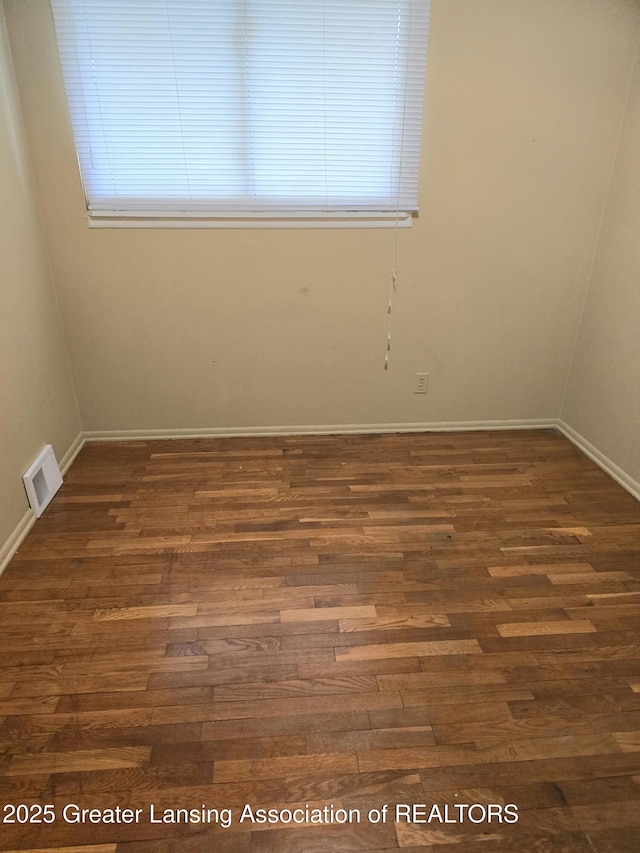3701 Sumpter St, Lansing, MI 48911 - empty room with dark wood-style floors and healthy amount of natural light