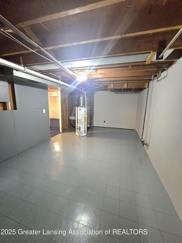 3701 Sumpter St, Lansing, MI 48911 - unfinished basement featuring water heater