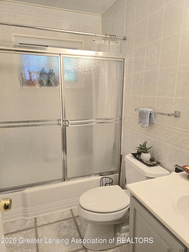 3701 Sumpter St, Lansing, MI 48911 - full bathroom with tile walls, vanity, enclosed tub / shower combo, tile patterned floors, and backsplash