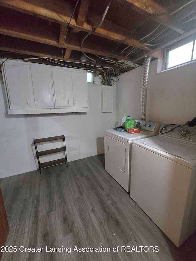 3701 Sumpter St, Lansing, MI 48911 - laundry area featuring washing machine and clothes dryer, cabinet space, dark wood-type flooring, and electric panel