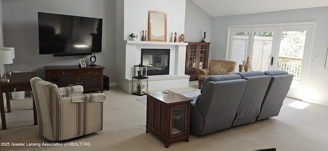 1945 W Danbury, Okemos, MI 48864 - living area featuring light carpet, a glass covered fireplace, and lofted ceiling
