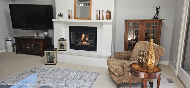 1945 W Danbury, Okemos, MI 48864 - living area featuring carpet floors and a glass covered fireplace