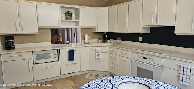 1945 W Danbury, Okemos, MI 48864 - kitchen featuring white appliances, white cabinetry, light countertops, and open shelves