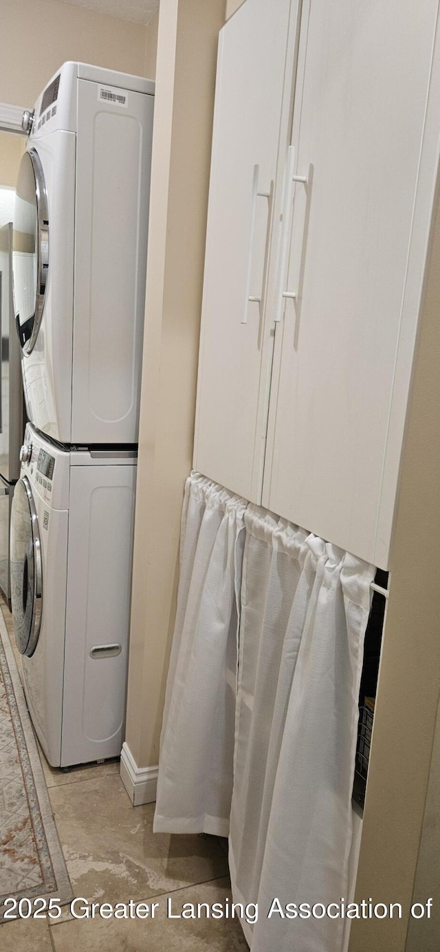 1945 W Danbury, Okemos, MI 48864 - laundry room with stacked washer / drying machine and baseboards