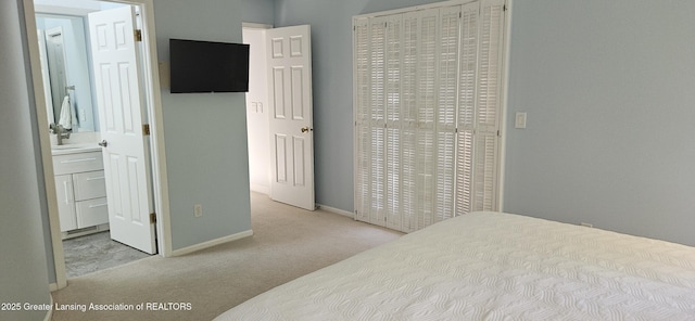 1945 W Danbury, Okemos, MI 48864 - carpeted bedroom featuring baseboards and ensuite bathroom