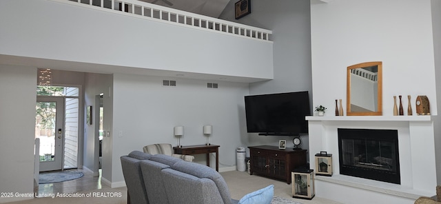 1945 W Danbury, Okemos, MI 48864 - living room with a high ceiling, carpet floors, and a glass covered fireplace