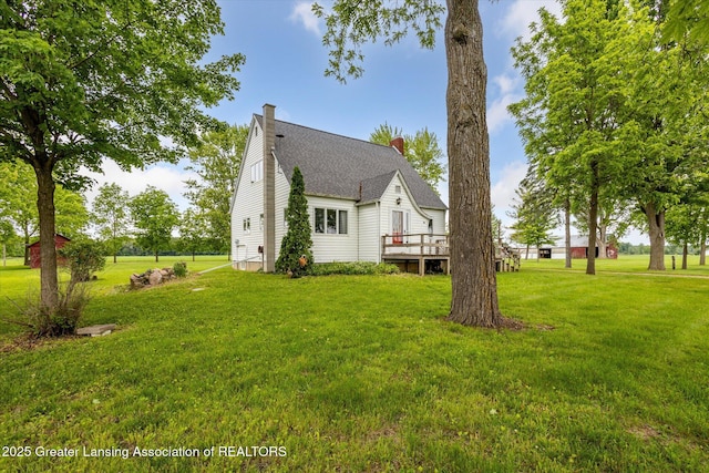 16544 S Chapin Rd, Elsie, MI 48831 - view of property exterior featuring a wooden deck, a lawn, and a chimney